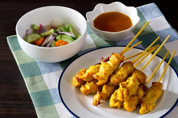 Pork Satay with peanut sauce and vegetables salad sauce on napery cloth