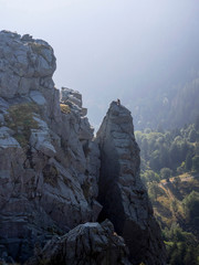 View of hiker seen climbing up over peak of Martinswand mountain, Hohneck, Vosges, France