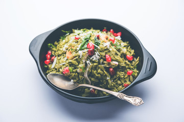 Hariyali Poha / Green Masala Pohe or flattened rice served in a bowl, selective focus