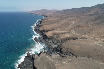 dawn between desert mountains and cliffs almost without vegetation with the Atlantic Ocean imposing
