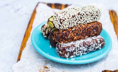 Chocolate energy protein bars with nuts, seeds, dry fruits. Healthy dietary snack. Vegan dessert. Chia, flax seeds, coconut, sesame, pumpkin, sunflower seeds.
