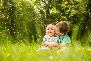 Two little brothers having fun in the garden