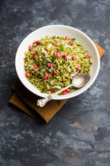 Hariyali Poha / Green Masala Pohe or flattened rice served in a bowl, selective focus