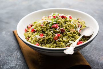 Hariyali Poha / Green Masala Pohe or flattened rice served in a bowl, selective focus