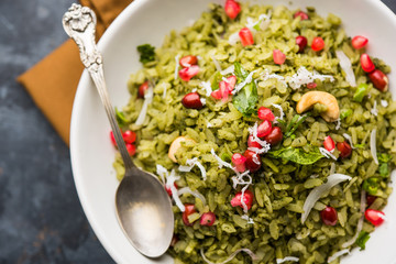 Hariyali Poha / Green Masala Pohe or flattened rice served in a bowl, selective focus