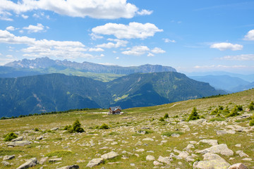 Fototapeta na wymiar View from an alp meadow with a mountain hut
