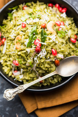 Hariyali Poha / Green Masala Pohe or flattened rice served in a bowl, selective focus
