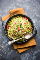Hariyali Poha / Green Masala Pohe or flattened rice served in a bowl, selective focus