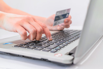 female hands typing on laptop keyboard