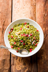 Hariyali Poha / Green Masala Pohe or flattened rice served in a bowl, selective focus
