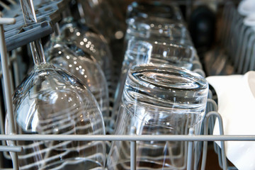 clean empty glasses in opened dishwasher clowe up