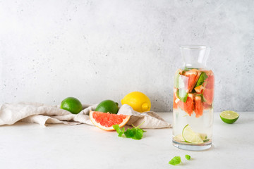 Bottle of cool infused water with fresh grapefruit, lime and mint, (lemonade, cocktail). Detox drink, health care, fitness, diet concept.