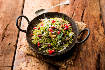 Hariyali Poha / Green Masala Pohe or flattened rice served in a bowl, selective focus