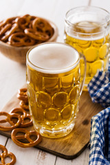 Oktoberfest beer and pretzel on wooden table. 