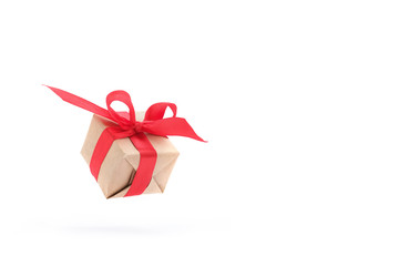 Gift box with red ribbon isolated on white background. levitation. milimalism. copyspace. Concept sales, shopping, christmas holidays and birthday