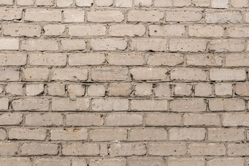 Beautiful horizontal texture of part of a old crashed brick gray wall is on the photo