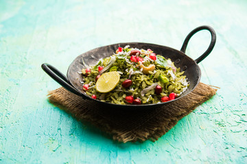 Hariyali Poha / Green Masala Pohe or flattened rice served in a bowl, selective focus