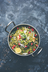 Hariyali Poha / Green Masala Pohe or flattened rice served in a bowl, selective focus