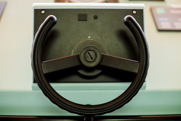 Ship steering wheel on panel in control room on international cargo ship in the ocean for navigater on ocean. © Koonsiri