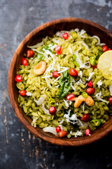 Hariyali Poha / Green Masala Pohe or flattened rice served in a bowl, selective focus