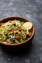 Hariyali Poha / Green Masala Pohe or flattened rice served in a bowl, selective focus