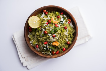 Hariyali Poha / Green Masala Pohe or flattened rice served in a bowl, selective focus