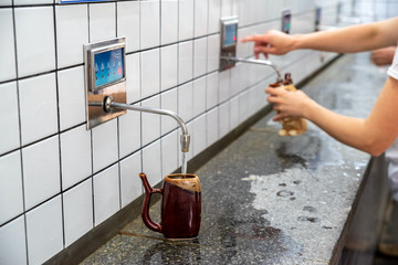Water is poured into a special cup in the pump room of mineral waters,