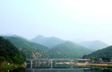 Fototapeta na wymiar A view of Ganhyeon Bridge reflected upon the Seom river at Wonju, South Korea.