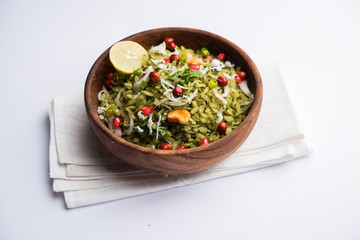 Hariyali Poha / Green Masala Pohe or flattened rice served in a bowl, selective focus