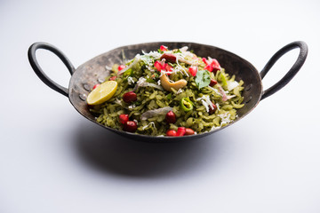 Hariyali Poha / Green Masala Pohe or flattened rice served in a bowl, selective focus