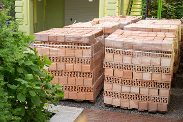 red bricks on pallets folded for construction
