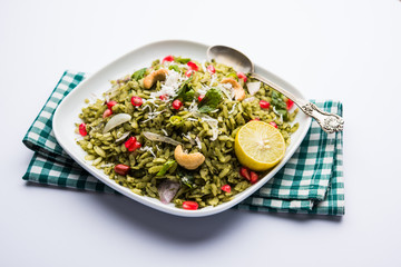 Hariyali Poha / Green Masala Pohe or flattened rice served in a bowl, selective focus