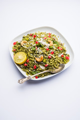 Hariyali Poha / Green Masala Pohe or flattened rice served in a bowl, selective focus