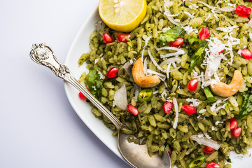 Hariyali Poha / Green Masala Pohe or flattened rice served in a bowl, selective focus