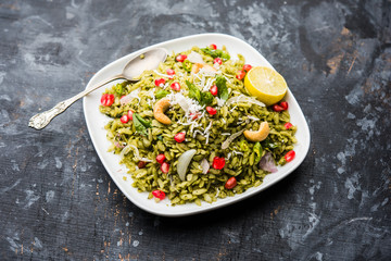 Hariyali Poha / Green Masala Pohe or flattened rice served in a bowl, selective focus