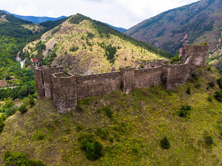 Fototapeta na wymiar Ruins of medieval fortress Maglic on top of hill by the Ibar river in Serbia. Aerial view. Valley of this river is also called Lilac valley.