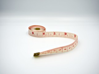 Upside down shot on the measuring tape with white background and showing both centimeters and inches scale