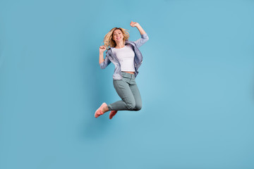 Full body photo of pretty lady raising arms wearing pants trousers isolated over blue background