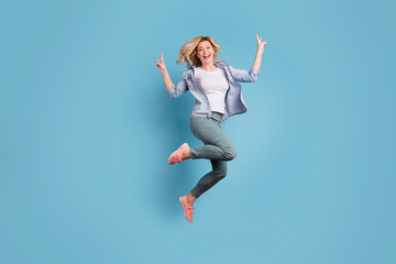 Fototapeta na wymiar Full size photo of cheerful person jumping moving making v-signs laughing isolated over blue background