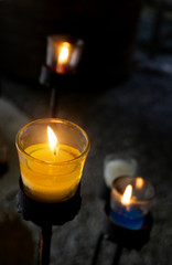 Candles placed in glass, placed on an iron base.
