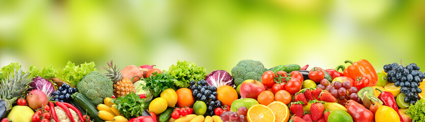 Fruits and vegetables on green blurred background.