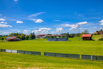 Obraz premium green football field in the rustic area