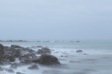 Magical evening atmosphere at the seashore with stone rock near Kaikoura, New Zealand 