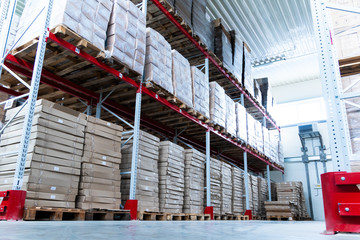 storage warehouse and racks on which there are cardboard boxes with finished products