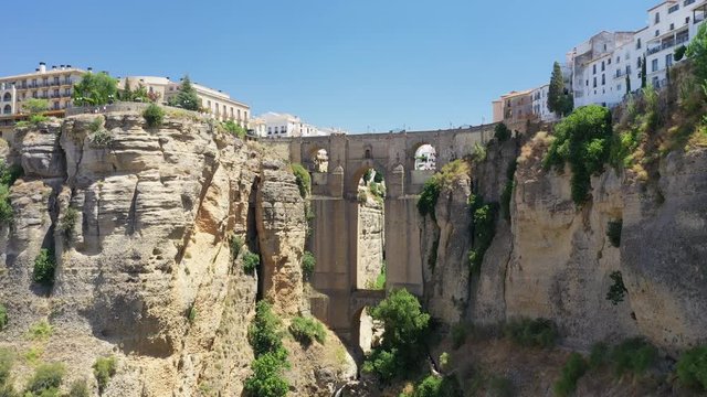 Aerial view of cityscape of Ronda, famous historic city with impressive arch bridge Puente Nuevo over gorge El Tajo - landscape panorama of Andalusia from above, province of Malaga, Spain, Europe