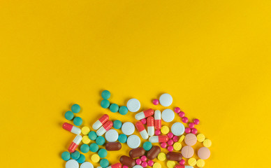 medicine pills,  capsules over yellow background