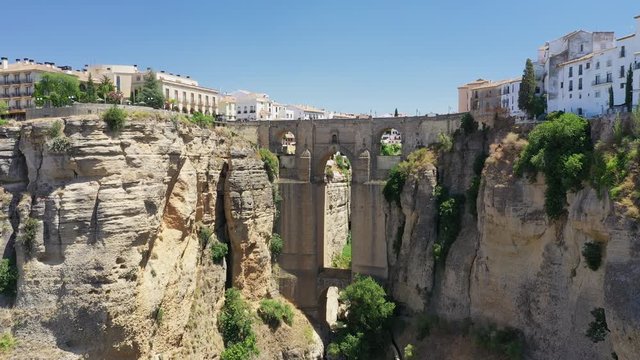Aerial view of cityscape of Ronda, famous historic city with impressive arch bridge Puente Nuevo over gorge El Tajo - landscape panorama of Andalusia from above, province of Malaga, Spain, Europe