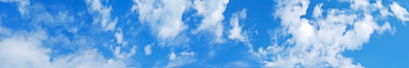Panorama of blue summer sky with light clouds on a sunny day. Natural background