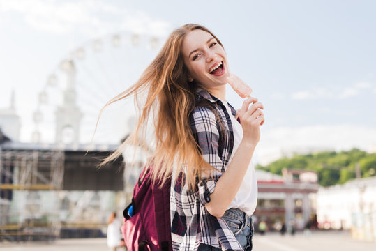 Fashionable Young Woman Holding Popsicle With Mouth Open