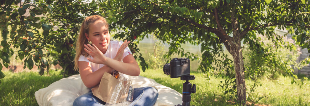 Teen girl shoots a blog on the topic of zero waste and life without plastic in nature in front of the camera, the idea of pollution of nature and solving problems among young people.Baner